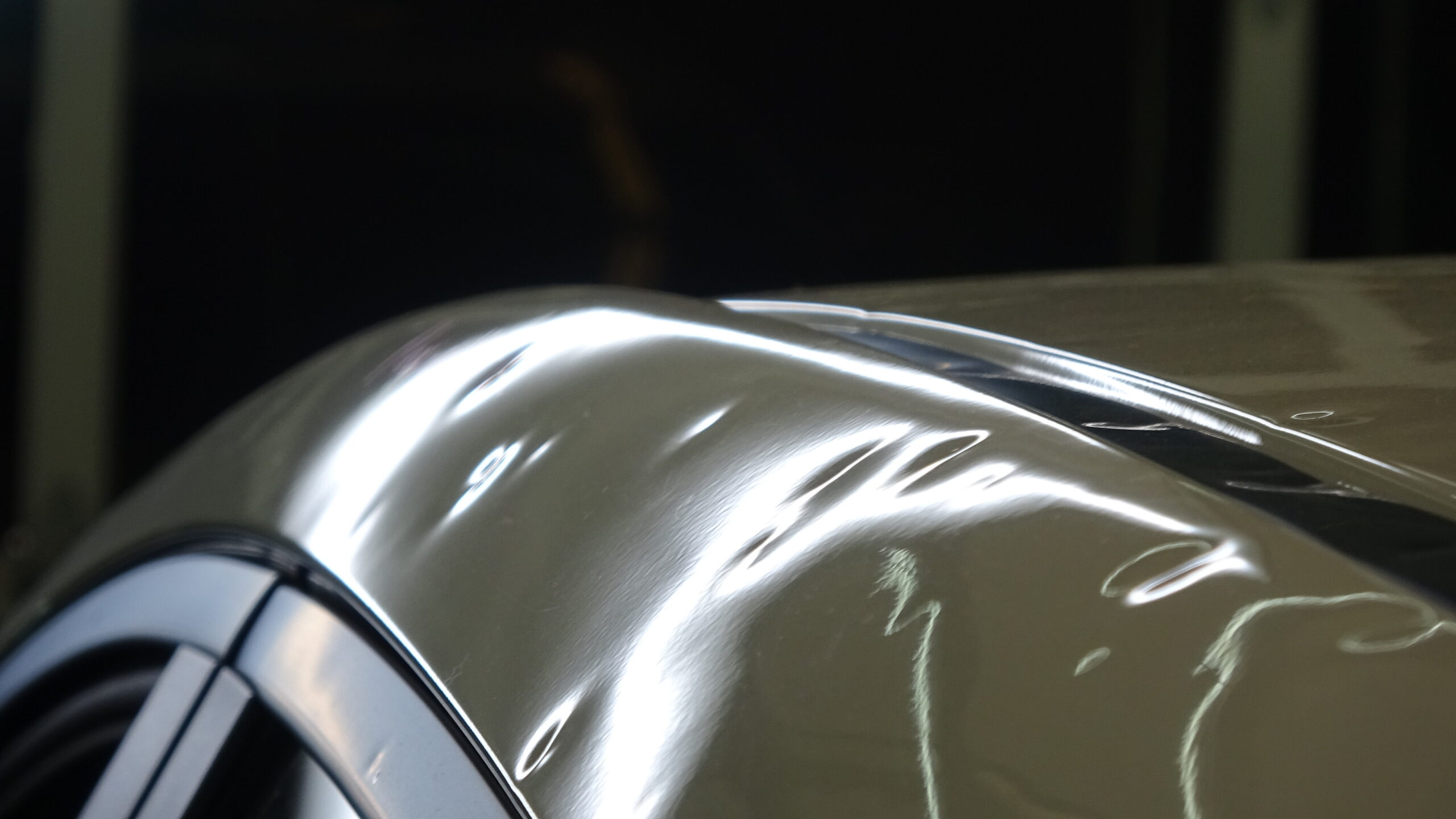 Hail dents marked for insurance inspection under PDR lighting, Denton County — quarter panel